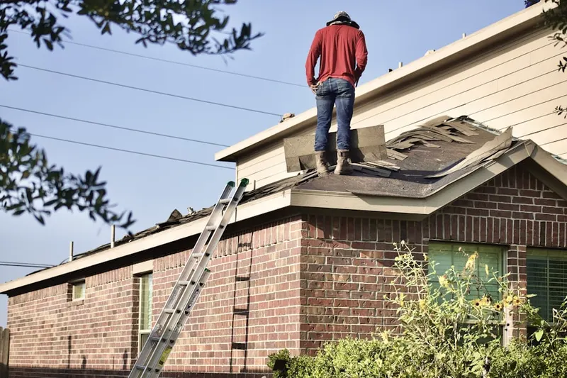 Professional roofer working on a residential roof in North Hempstead